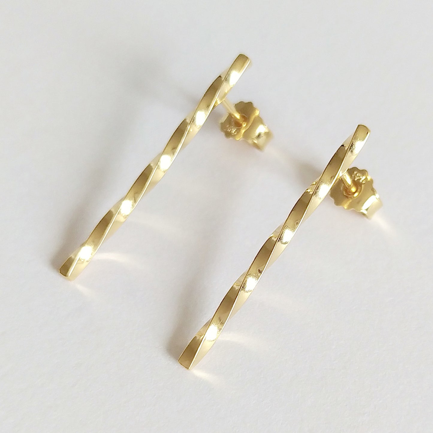 Adeja | golden twisted bar stud earrings